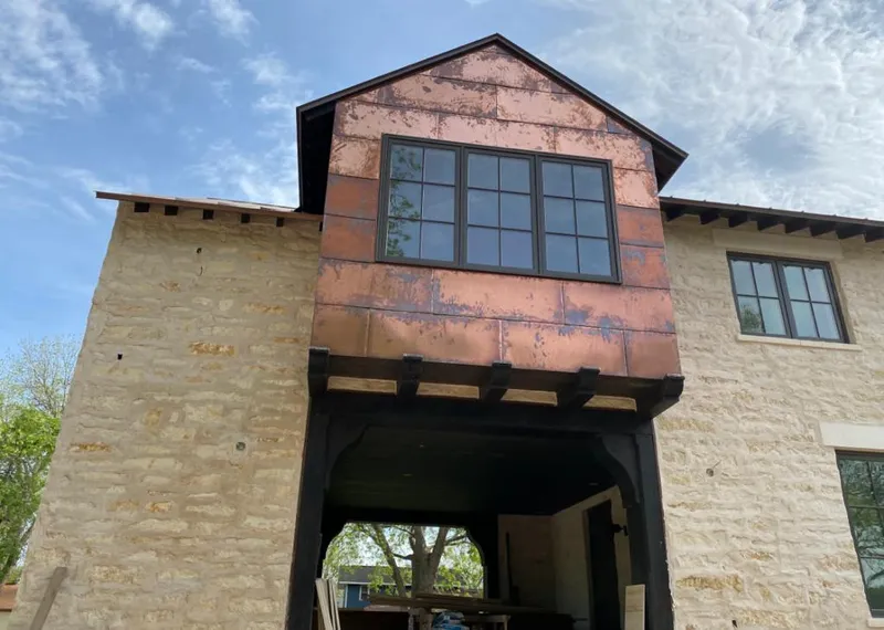 Copper metal panel facade on a stone building for Skylight Installation in Parker